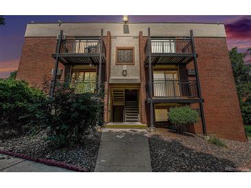 Apartment building exterior features two-story balconies and brick facade at 5995 W Hampden Ave # 18C, Denver, CO 80227