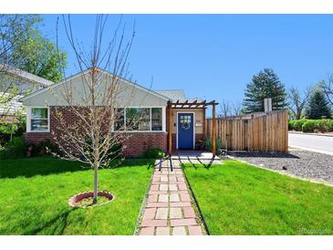 Charming brick home with a blue door and a pergola leading to the entrance at 2301 E Yale Ave, Denver, CO 80210