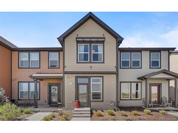 Charming townhome featuring neutral siding, trim, and tidy front yard landscaping at 11440 E Martin Luther King Jr Blvd, Denver, CO 80238