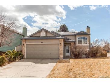 Charming two-story home with attached two car garage and well-manicured front yard at 9182 Weeping Willow Ct, Highlands Ranch, CO 80130