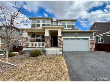 Charming two-story home featuring a two-car garage and a beautifully maintained front yard at 12164 Poplar St, Thornton, CO 80602