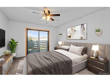 Bright main bedroom features a ceiling fan, sliding glass door and comfortable contemporary decor at 7665 E Eastman Ave # D304, Denver, CO 80231