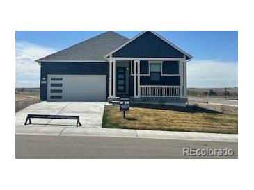 Charming single-story home showcasing a pristine front yard and attached garage, perfect for comfortable living at 42998 Colonial Trl, Elizabeth, CO 80107