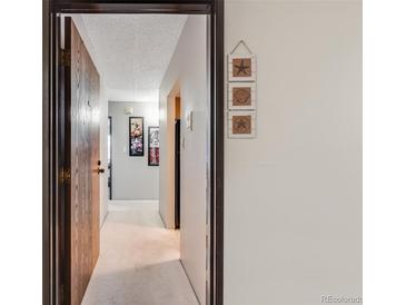 Inviting hallway with neutral tones and stylish beach themed decorations on the wall at 7770 W 38Th Ave # 207, Wheat Ridge, CO 80033