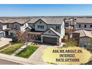 Charming two-story home with a well-manicured lawn, inviting curb appeal, and a convenient attached garage at 11046 Pastel Pt, Parker, CO 80134