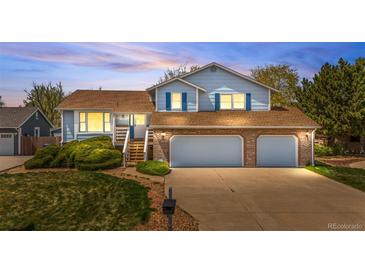 Charming two-story home featuring a brick facade, well-maintained lawn and three-car garage at 835 S Geneva St, Aurora, CO 80247
