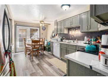 Charming eat-in kitchen with gray cabinets, wood-look flooring, and stainless steel sink at 1143 Lamar St # 6, Lakewood, CO 80214