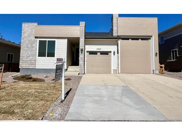 Charming single-Gathering home with a two-car garage and well-manicured lawn on a sunny day at 25025 E 41St Ave, Aurora, CO 80019
