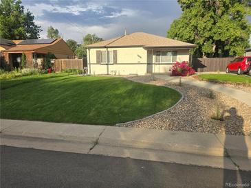Charming single-story home with well-manicured lawn, garden, and inviting curb appeal at 3540 Niagara St, Denver, CO 80207
