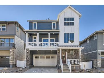 Charming two-story home with a covered porch, stone accents, and attached two car garage at 2088 S Haleyville Way, Aurora, CO 80018