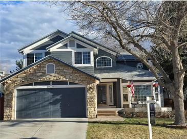 Charming two-story home with a stone-accented garage and inviting front porch at 19346 E Prentice Ln, Centennial, CO 80015