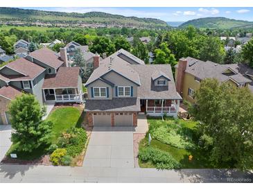 Beautiful two-story home featuring a well-manicured lawn, two-car garage and mountain views at 18 Blue Sage, Littleton, CO 80127