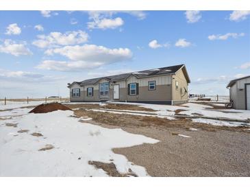 Ranch style home with attached garage, situated on spacious lot at 4220 Headlight Rd, Strasburg, CO 80136