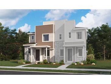 Stunning townhome showcasing a modern architectural design and manicured landscaping at 6648 N Nepal Ct, Aurora, CO 80019
