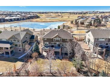 Expansive backyard featuring multi-level deck overlooking green common area, perfect for entertaining at 7680 S Blackstone Pkwy, Aurora, CO 80016