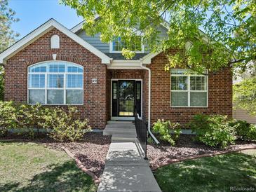 Charming brick home featuring a well-maintained front yard and inviting entrance at 6900 W Grant Ranch Blvd # 49, Littleton, CO 80123