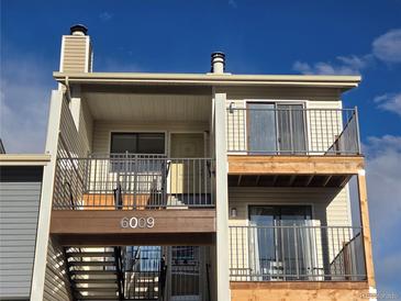 Two-story condo with private balconies and stairwell access to front door, featuring a neutral color scheme at 6009 Yarrow St # C, Arvada, CO 80004
