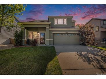 Charming two-story home featuring a well-manicured lawn and a two-car garage at 10359 Tracewood Dr, Highlands Ranch, CO 80130