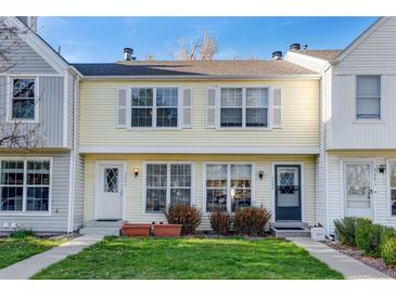 Charming two-story townhouse with well-maintained lawn and inviting curb appeal at 3295 S Estes St, Lakewood, CO 80227