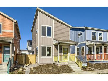 Two-story modern home with gray siding, yellow porch, and landscaping at 10251 E 62Nd Pl, Denver, CO 80238