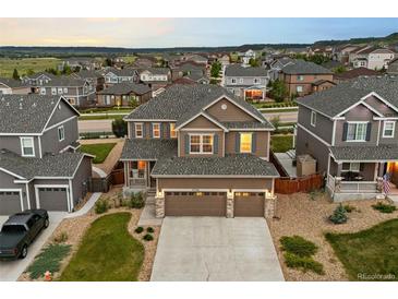 Beautiful two-story home boasts a three-car garage, landscaped yard, and mountain views at 7734 Blue Water Dr, Castle Rock, CO 80108