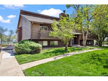 Charming brown townhome featuring a private balcony and lush green lawn at 2630 Juniper Ave # 37-5, Boulder, CO 80304