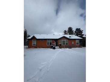 Ranch style home with snowy yard at 10871 Kitty Dr, Conifer, CO 80433