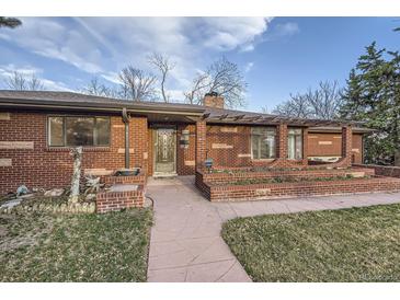 Charming single-story brick home with a well-maintained front yard and covered entry at 8060 Meade St, Westminster, CO 80031