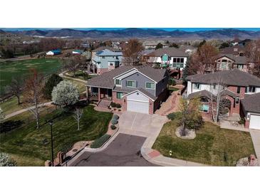 Aerial view of two-story home with manicured lawn, mature trees, and neighborhood setting at 6271 Mcintyre Way, Golden, CO 80403