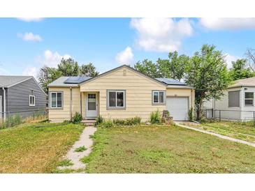 Charming single-story home features a well-maintained front lawn, and solar panels at 1708 Akron St, Aurora, CO 80010