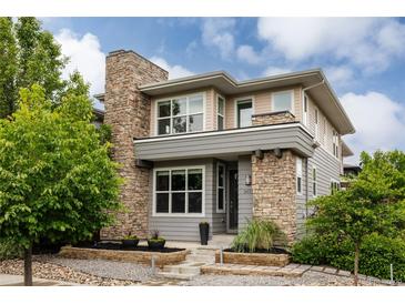 Contemporary home with stone accents, well-maintained landscaping, and a welcoming entrance at 3473 Beeler St, Denver, CO 80238
