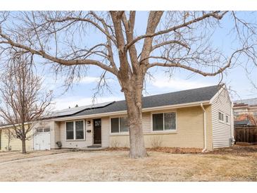 Charming single-story home with solar panels and a mature tree in the front yard at 4545 E Harvard Ave, Denver, CO 80222