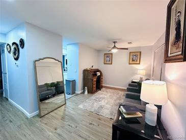 A warm living room, complete with natural lighting, vintage roll top desk and modern decor at 12223 E Ford E Ave # 12223, Aurora, CO 80012