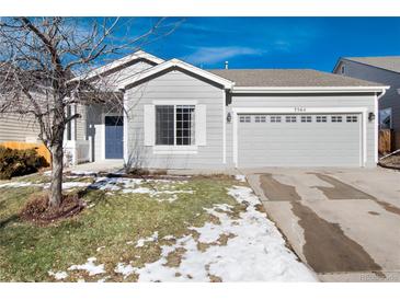 Gray house with two-car garage, and a small front yard at 3564 S Jebel Cir, Aurora, CO 80013