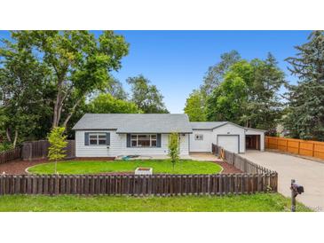 Charming single-story home with a fenced yard and detached garage, perfect for families at 4912 Indiana St, Golden, CO 80403