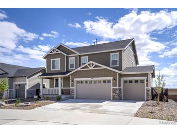 Two-story home showcasing a spacious three-car garage, covered porch, and modern architectural details at 188 S Waterloo St, Aurora, CO 80018