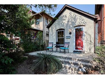 Charming front porch with a bright red door and seating area at 2731 W 32Nd Ave, Denver, CO 80211