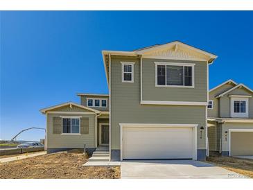 Two-story home featuring a two-car garage and modern architectural details at 4104 Grand Lake St, Brighton, CO 80601
