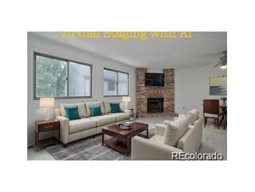 Bright living room features a fireplace and plenty of natural light at 4134 S Fraser Way # E, Aurora, CO 80014