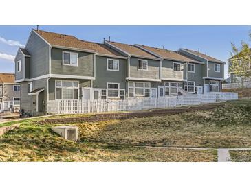 Row of townhomes with fenced yards and pleasant landscaping at 8199 Welby Rd # 3102, Denver, CO 80229