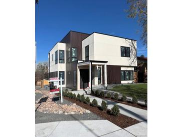 Modern two-story home for sale, boasting a stylish two-tone facade, clean landscaping, and a welcoming entryway at 1491 S York St, Denver, CO 80210