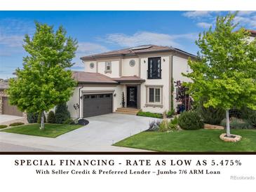 Charming two-story home features a well-manicured lawn, a two-car garage, and an inviting entrance at 10468 Ladera Dr, Lone Tree, CO 80124