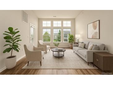 Bright living room features large windows, hardwood floors, and neutral decor at 9633 E 5Th Ave # 10304, Denver, CO 80230
