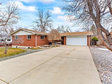 Charming brick home featuring an attached two-car garage and a spacious concrete driveway at 1050 Youngfield St, Golden, CO 80401