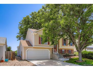 Charming two-story home with red shutters, attached garage and mature landscaping at 11200 W 102Nd Ave, Broomfield, CO 80021