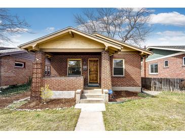 Charming brick bungalow with covered front porch, walkway, and freshly landscaped front yard at 2039 S Sherman St, Denver, CO 80210