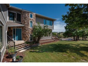 Charming two-story home featuring a stone facade and well-maintained front yard at 8853 N Awl Rd, Parker, CO 80138