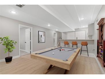 Finished basement featuring a pool table, bar area, and recessed lighting at 12992 W Jewell Cir, Lakewood, CO 80228