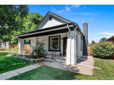 Charming home with landscaped front yard, stone accents, and inviting front porch at 3147 W 39Th Ave, Denver, CO 80211