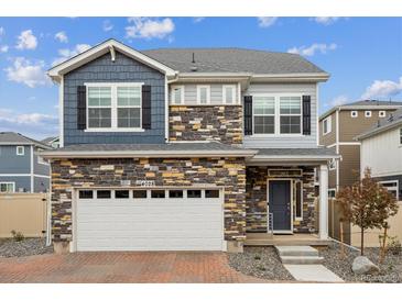 Beautiful two-story home featuring stone accents, neutral siding, and a two-car garage at 4028 N Rome St, Aurora, CO 80019